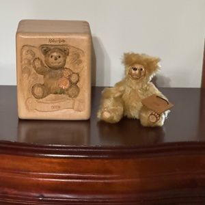Robert Raikes plush bear in a carved wooden box.